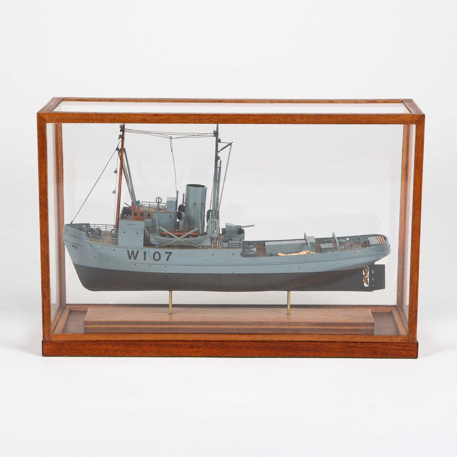 A scale model of the WWII Royal Navy Assurance class Admiralty tug HMS 'Adept' (W107).

The model of HMS Adept is fully rigged with aerial masts over bridge with binnacle, forward guns and rear Bofors gun midships, davits with lifeboats, in WWII