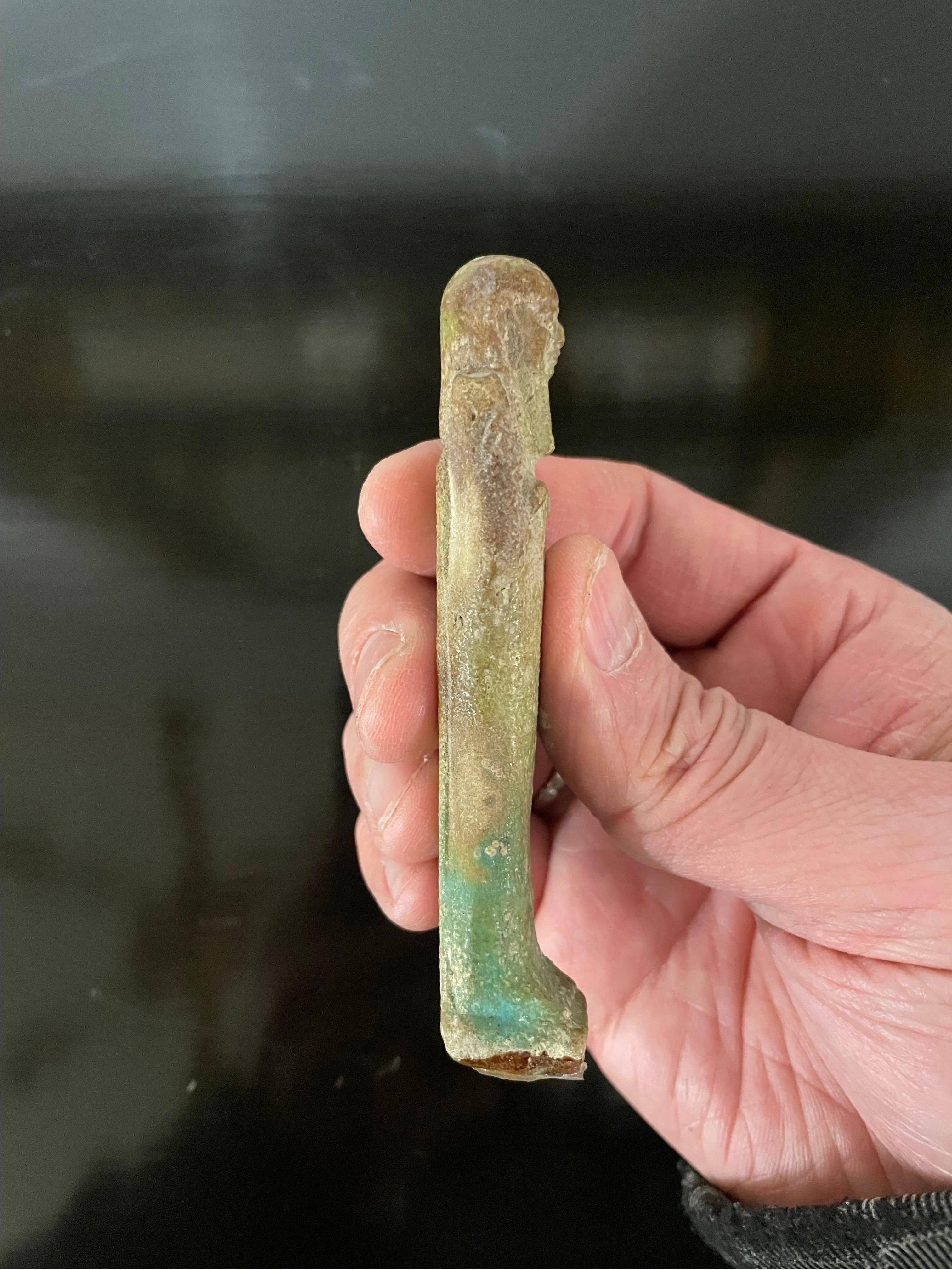 A finely modelled pale turquoise glazed Ushabti, Circa 26th Dynasty 664-525BC

Provenance: Sotheby’s London Lot 76 14/12/1981 for 725.00 Pounds sterling as part of a group lot.