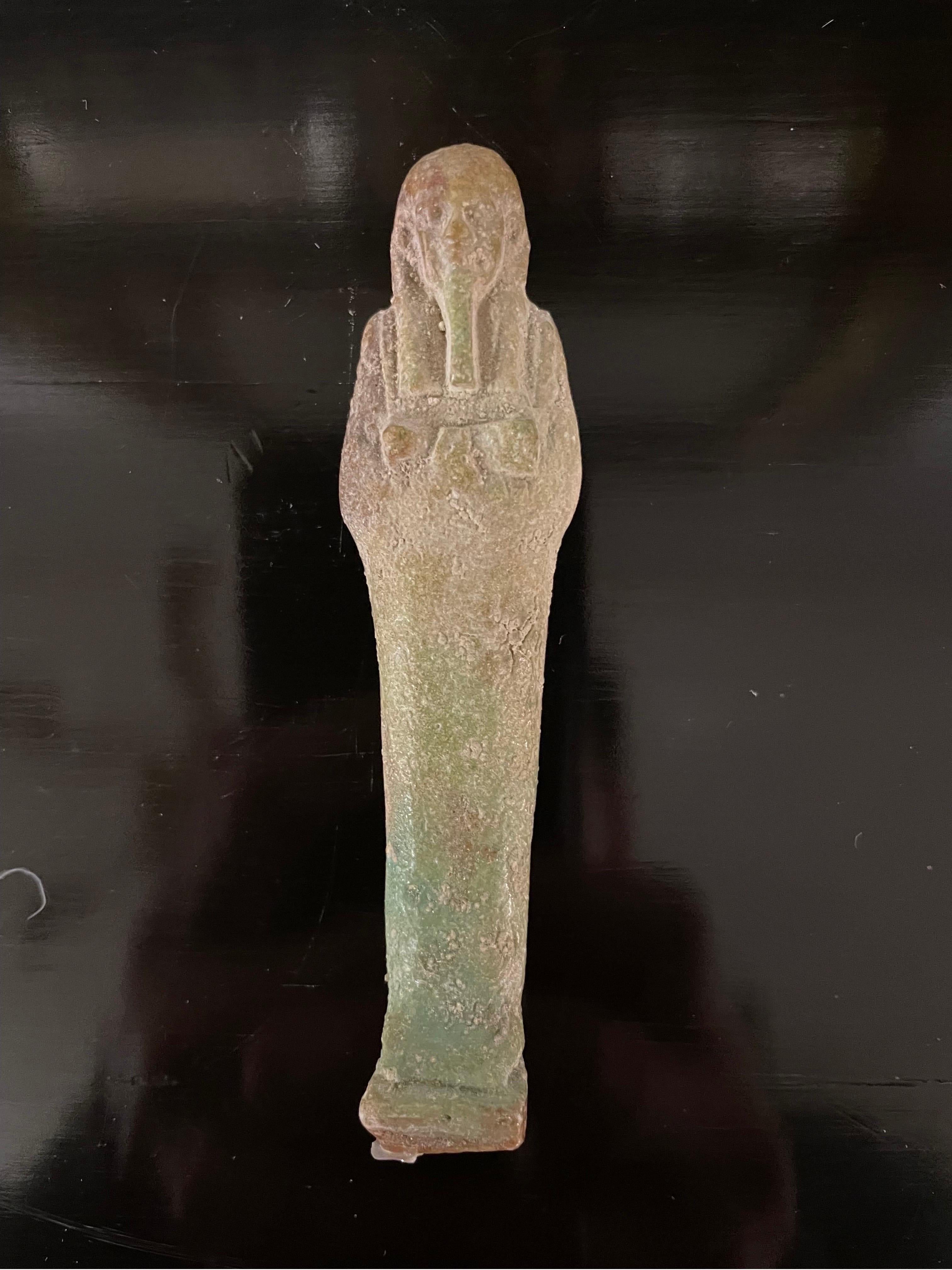Egyptian A modelled pale turquoise glazed Ushabti, Circa 26th Dynasty 664-525BC For Sale