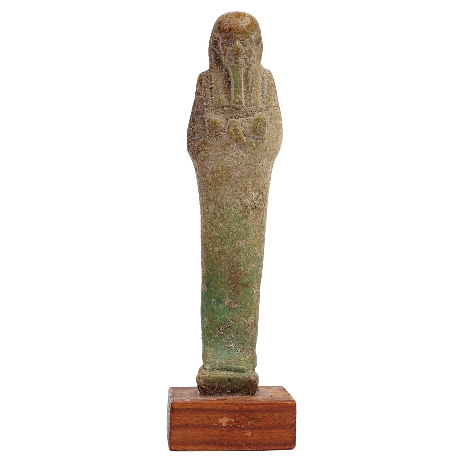 A modelled pale turquoise glazed Ushabti, Circa 26th Dynasty 664-525BC For Sale