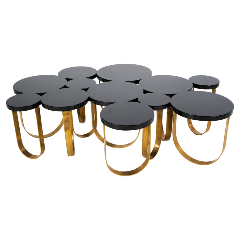 A Modern Coffee table With Solid Brass Legs and a Black Lacquer Top For