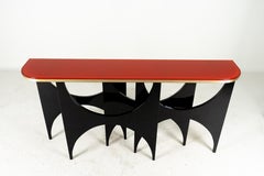 A Modern Console With Lacquered Base and Reverse-Painted Red Glass Top