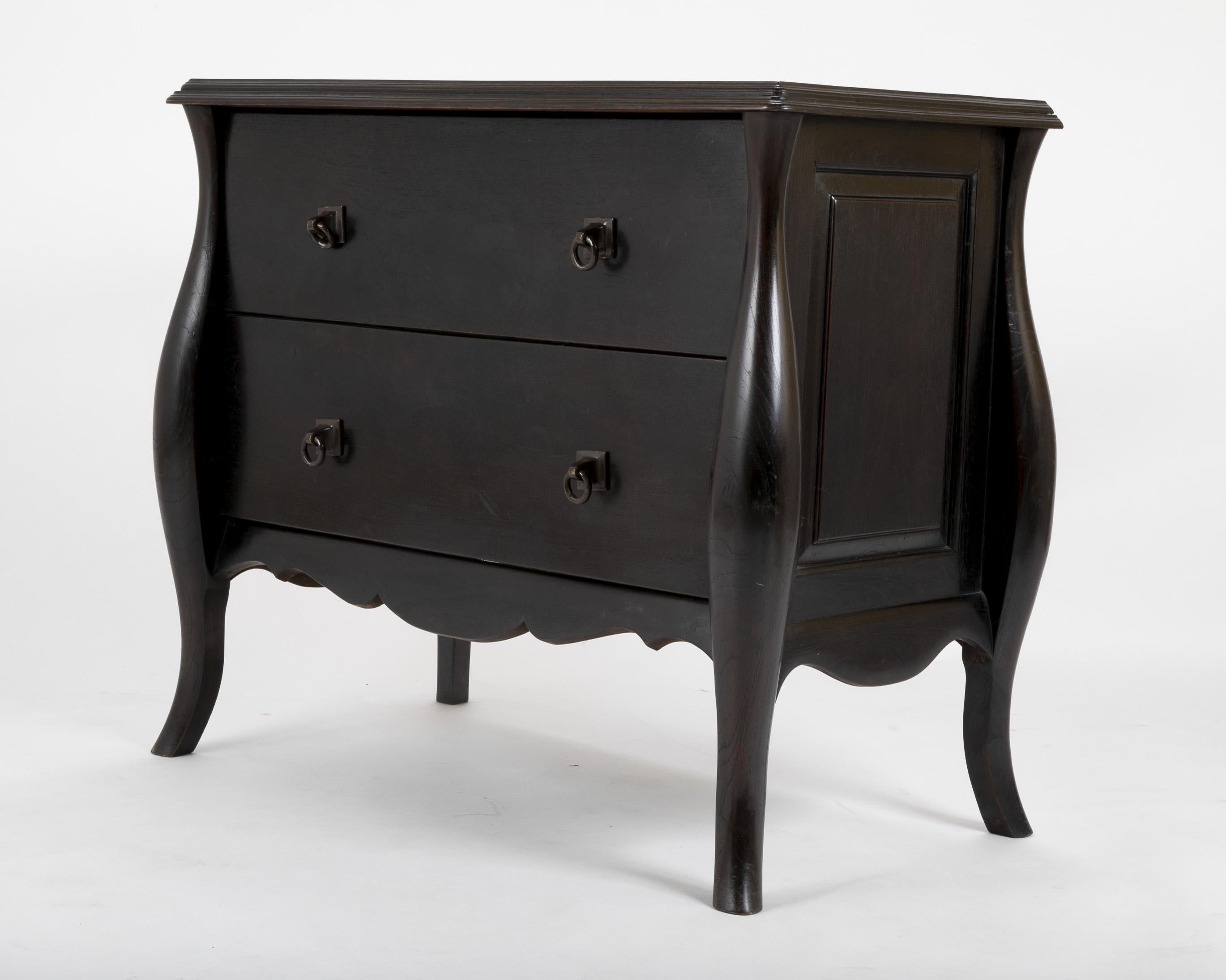 A commode with bronze loop handles in ebonized oak designed by the office of Alberto Pinto.
  
