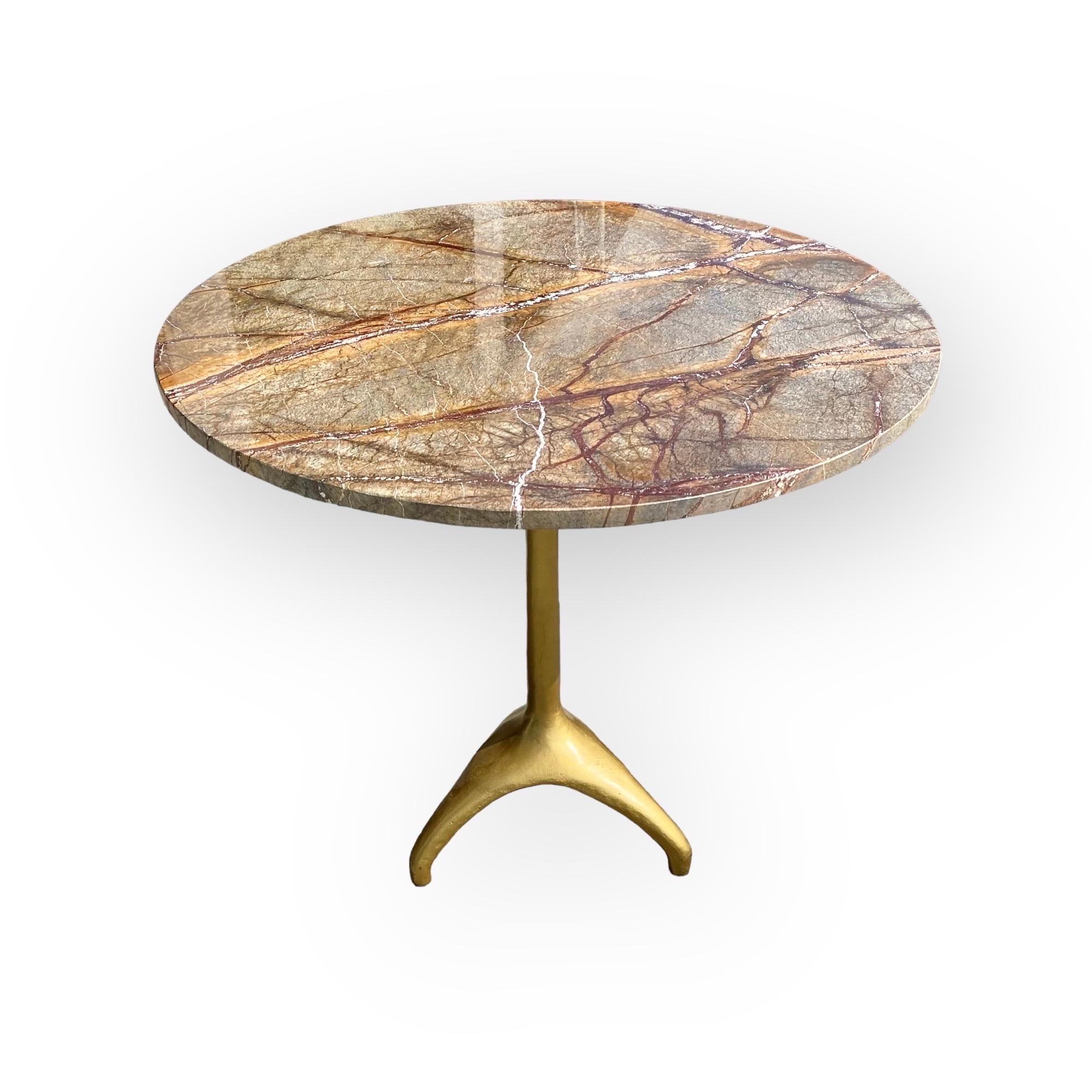 This Café Table's warm, polished Bidasar marble, has a gilt brass on cast-iron pedestal base. This round Café Table provides an inviting table for two when placed in a breakfast nook, a beautiful addition in your master bathroom, a gaming table in