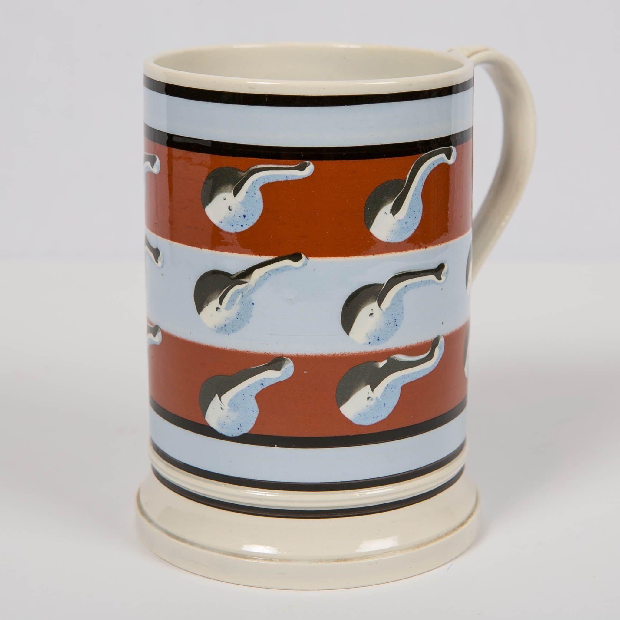 This beautiful mochaware mug was created by Don Carpentier at the end of the 20th century. Don dedicated himself to reviving the art of making mochaware. Mochaware is turned on a lathe. In order to make the pieces with the original techniques