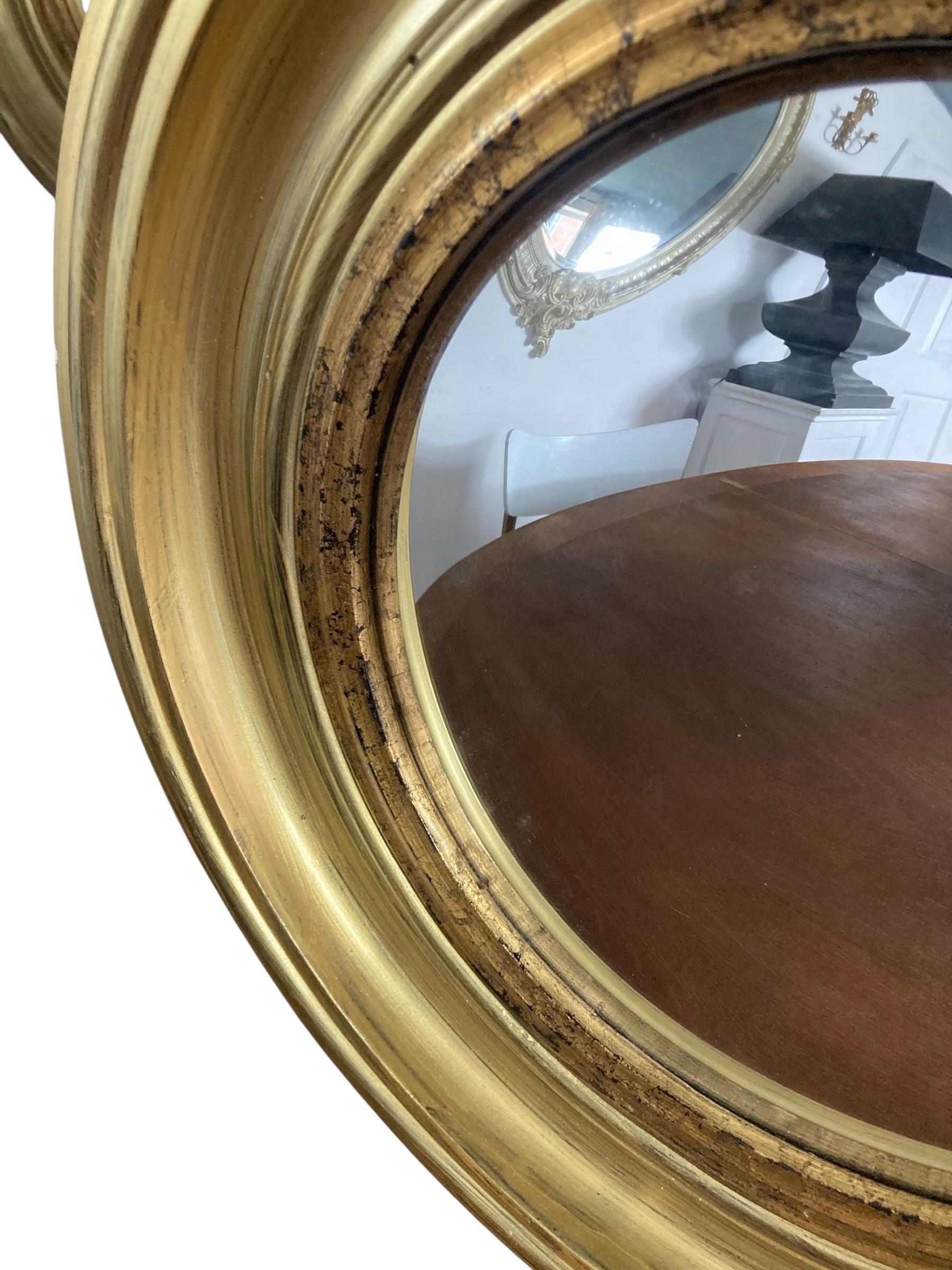 French A Modern Regency Style Gold Circular Convex Mirror with ebonsied Rim For Sale