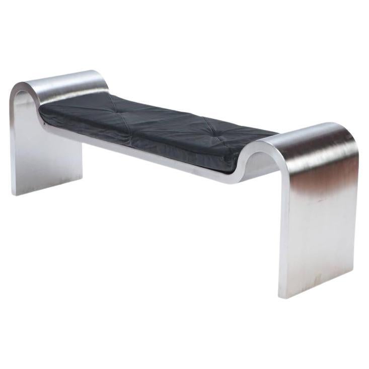 A Modern Stainless steel and leather bench in the manner of Karl Springer.