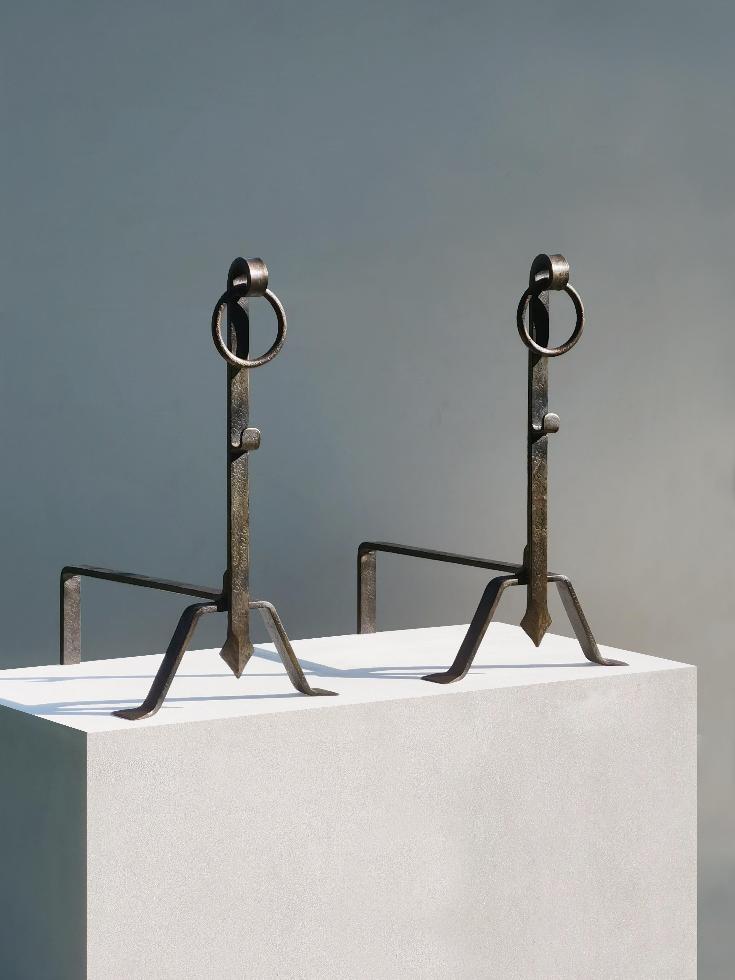 An important, wide, high, pair of andirons, Mid-Century-Modern, Modernist,  Brutalist, to be attributed, massive wrought iron structures strongly characterised by their 