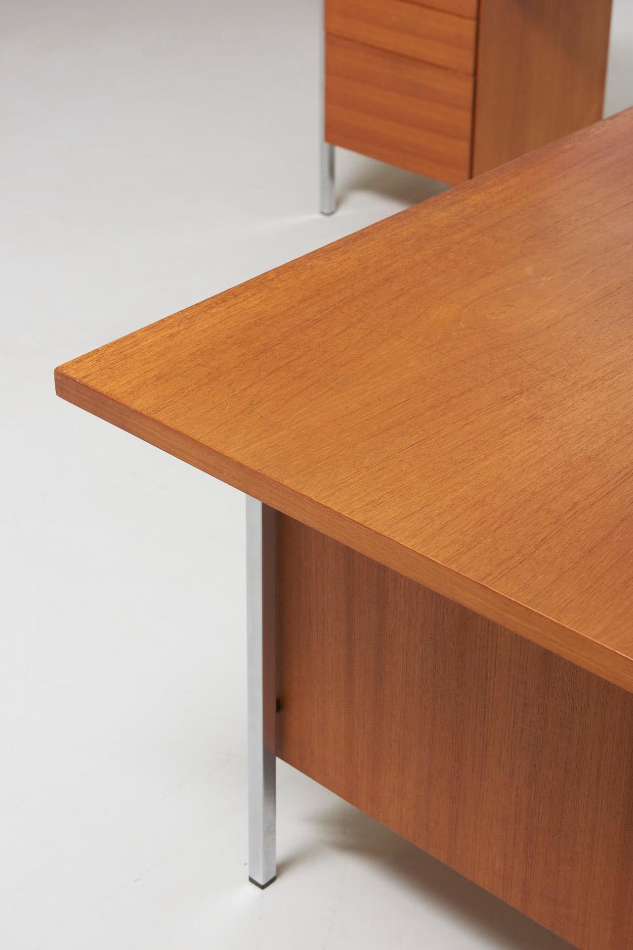 An L-shaped working space from the series model 1500. The executive desk (190 x 90 x 74) has a double pedestal, 3 drawers left and 2 drawers right, with a pair of keys. The smaller desk (115 x 48 x 66) can be placed behind or at side. Chrome-plated