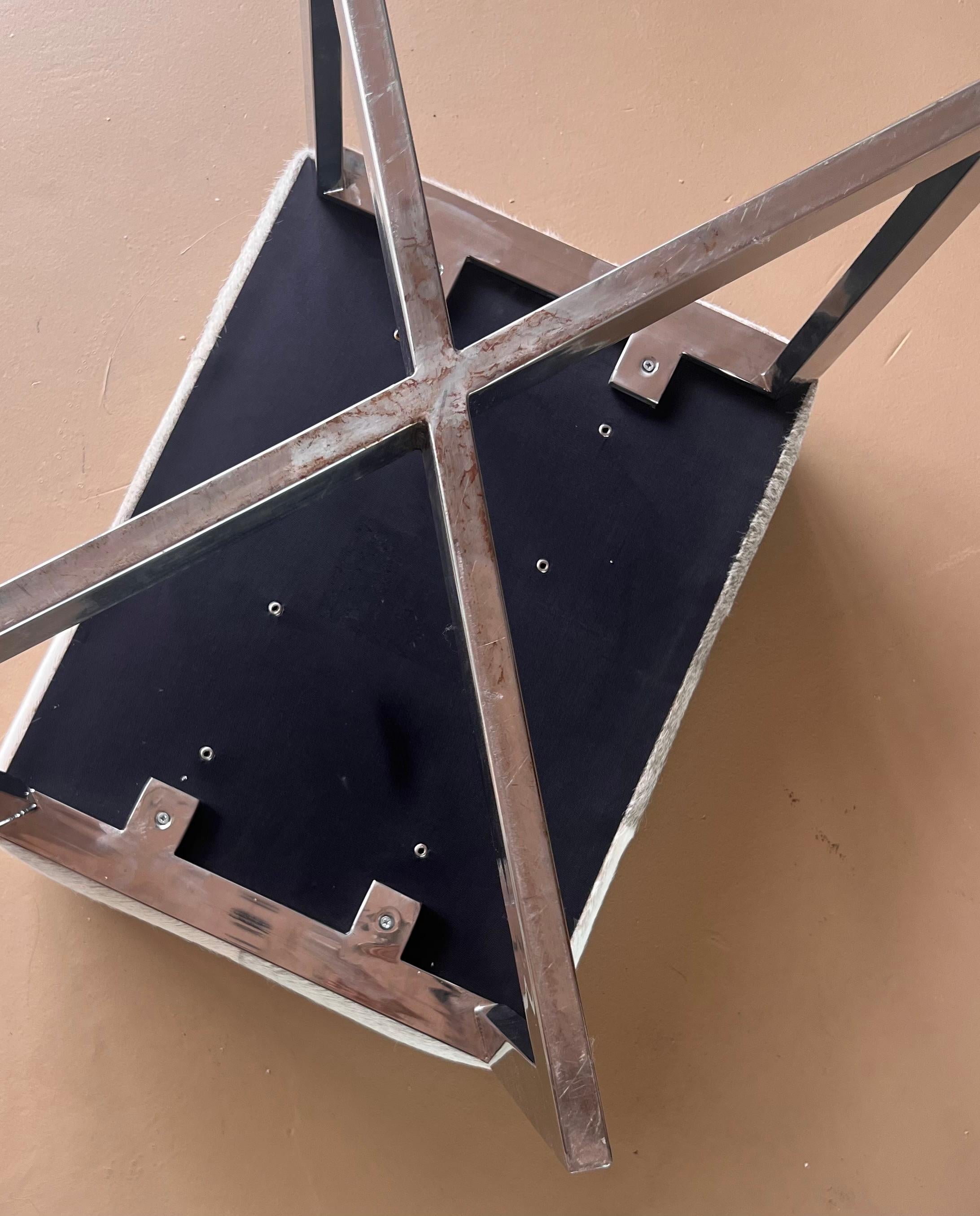 A modernist cowhide and chrome ottoman, 20th century. For Sale 7