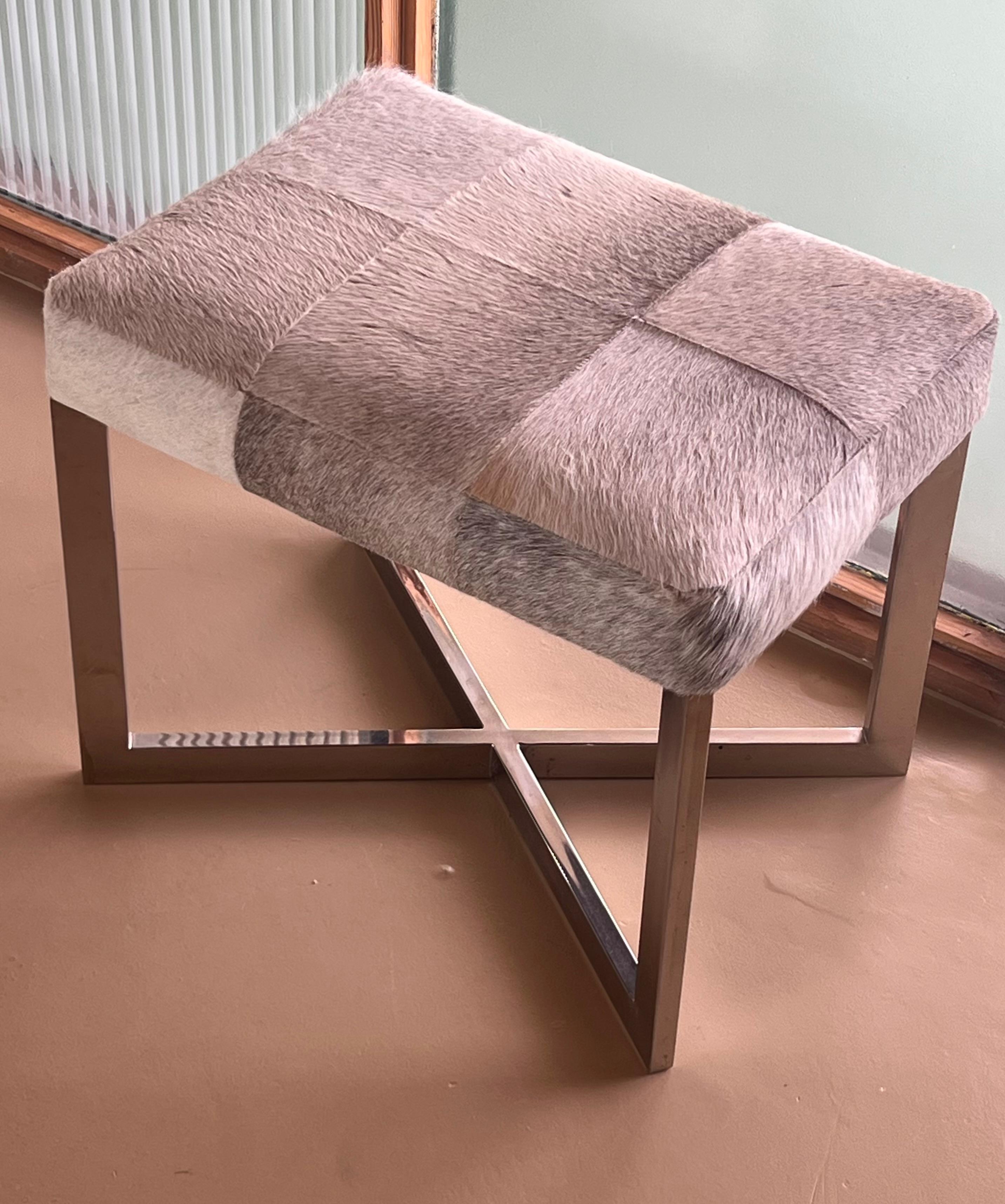 A modernist cowhide and chrome ottoman, 20th century. For Sale 11