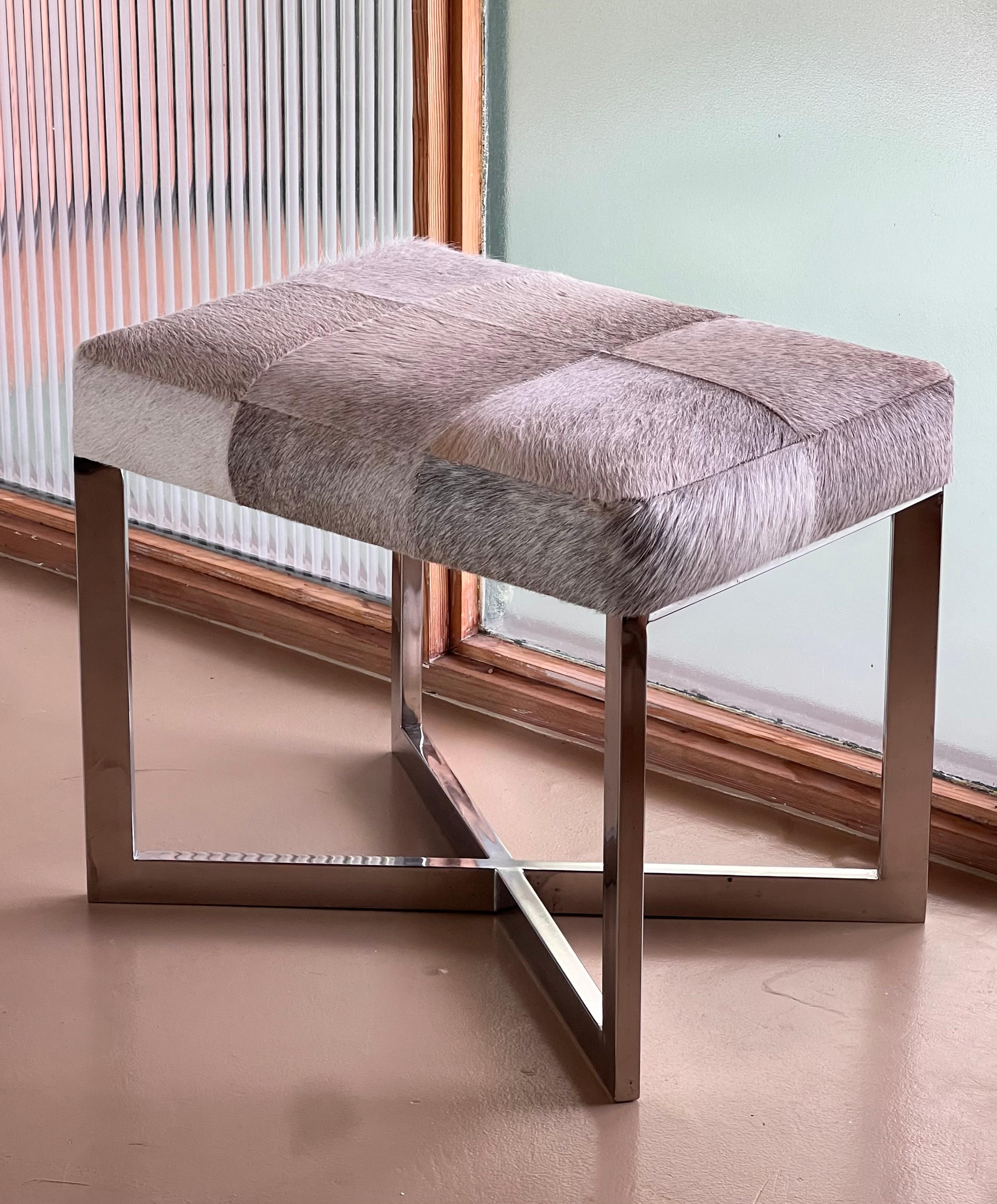 Mid-Century Modern A modernist cowhide and chrome ottoman, 20th century. For Sale