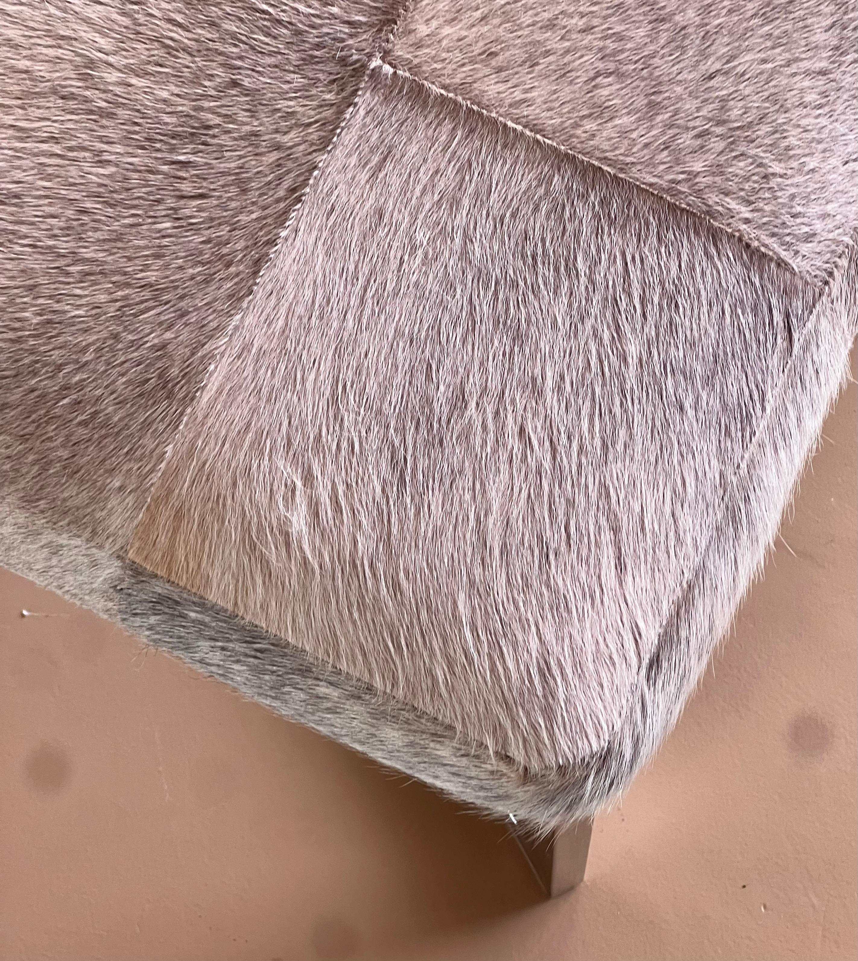 Cowhide A modernist cowhide and chrome ottoman, 20th century. For Sale