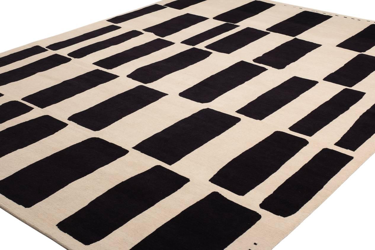 The first variation of our Coco Drum series, this design is woven from handspun Himalayan wool. Chocolate brown rectangles on a natural off-white background create a dynamic modernist rug. Original Design by Joseph Carini. This carpet is made from