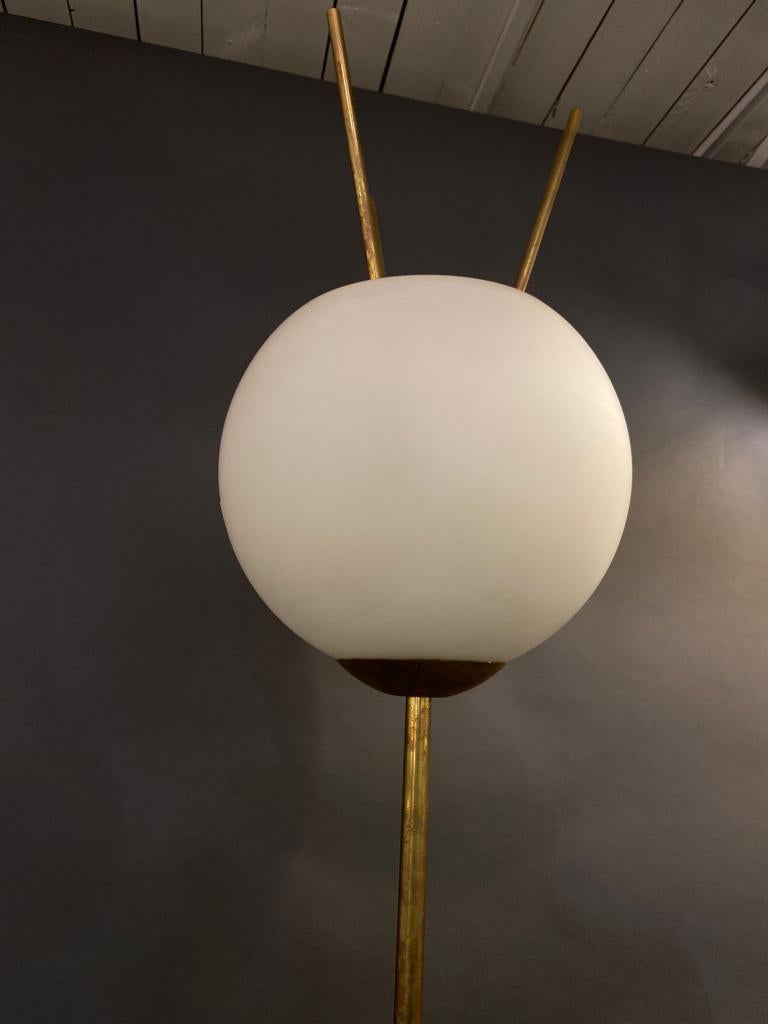 A modernist Italian floor lamp in brass and white frosted glass shade, circa 1980s.
The brass has a lovely vintage patina