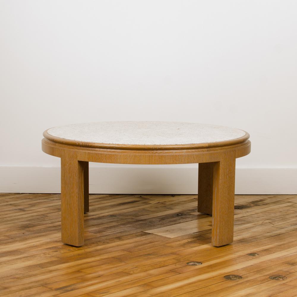 A modernist round cocktail table with a surface of delicate eggshell fragments on a solid oak base. Contemporary.