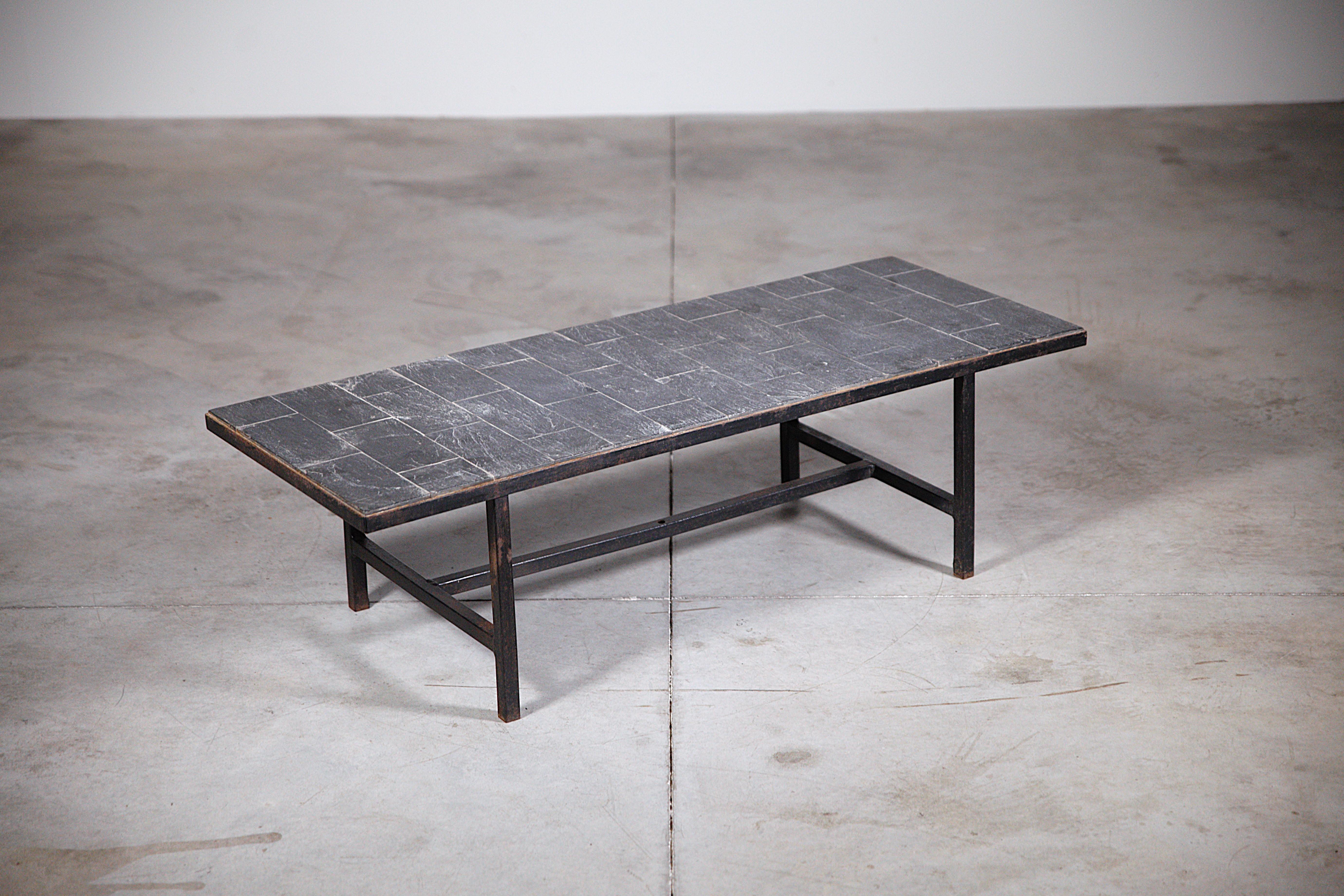 A Modernist Slate Stone Coffee Table France 1950's.

Anonymous French work.

Nice proportions.

Nice patina for the slate stone top.

Report : Traces of rust on the black lacquered metal frame ( please check the photos ) .