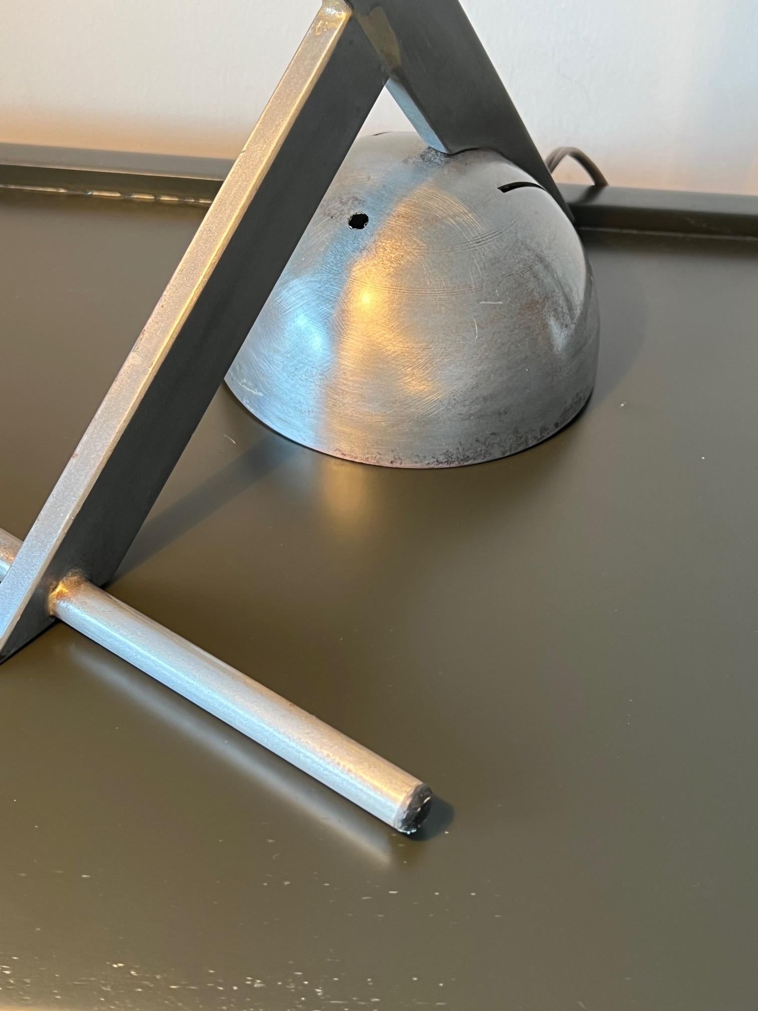 An unusual modernist table lamp, ca' 1980's. Polished steel.