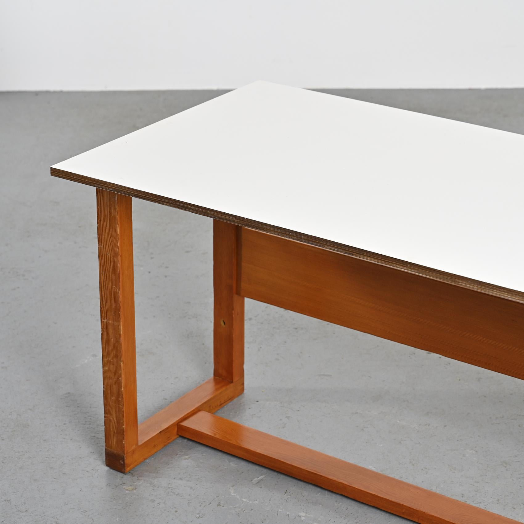 Fabriquée par le visionnaire Pierre Guariche, cette table polyvalente se transforme en table basse, en bureau ou même en table à manger selon vos besoins.

Méticuleusement construit en contreplaqué incurvé et orné d'un stratifié blanc crème, un