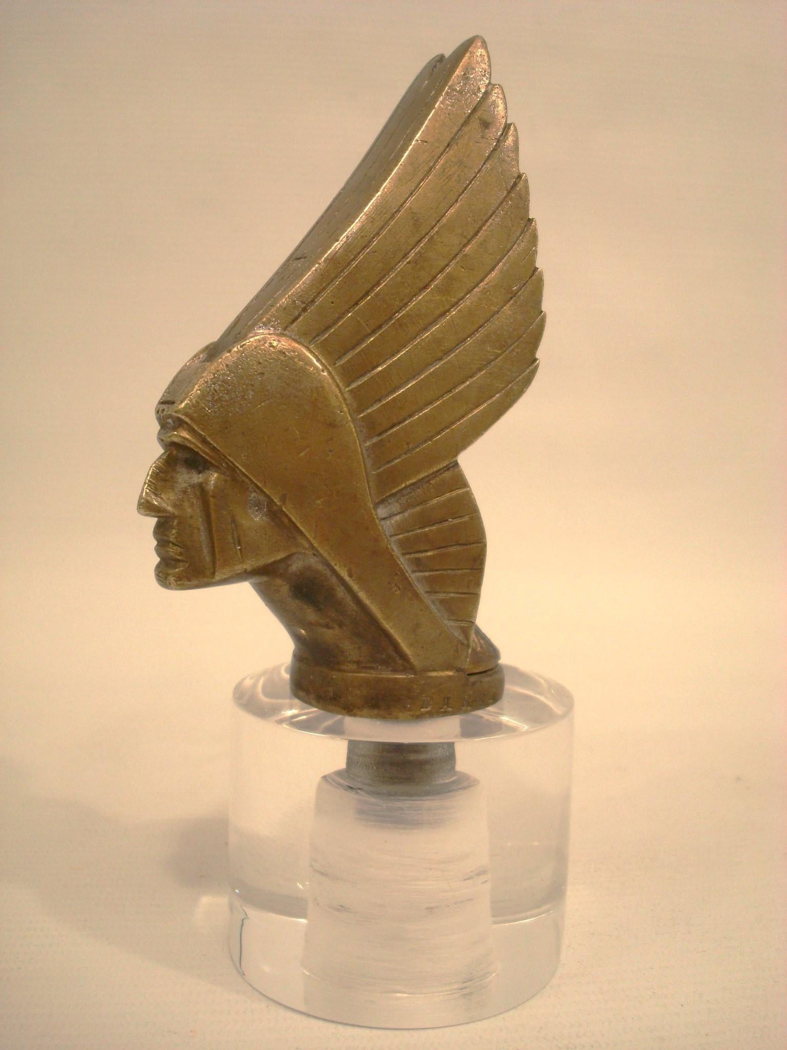 A 'Mohican' Car mascot / Hood Ornament by DAREL, circa 1930s.
Rare Art Deco Georges Darel Car Mascot. It come with a temperature gauge that you can see it from behind. Rare to find them complete. 
Beautifully crafted bronze sculpture of a Mohican