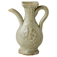 A Molded Longquan Celadon 'Fu Shou' Ewer, Ming Dynasty