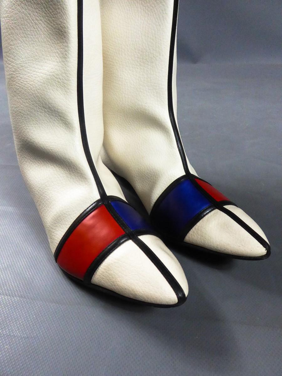 Circa 1965/1970
Europe

Pair of red, blue and white checkered vinyl boots inspired by the structured graphics of Piotr Mondrian's work, fashionable in 1965 by the Yves Saint Laurent iconic dress. White plastic vinyl skin imitating leather, checkered