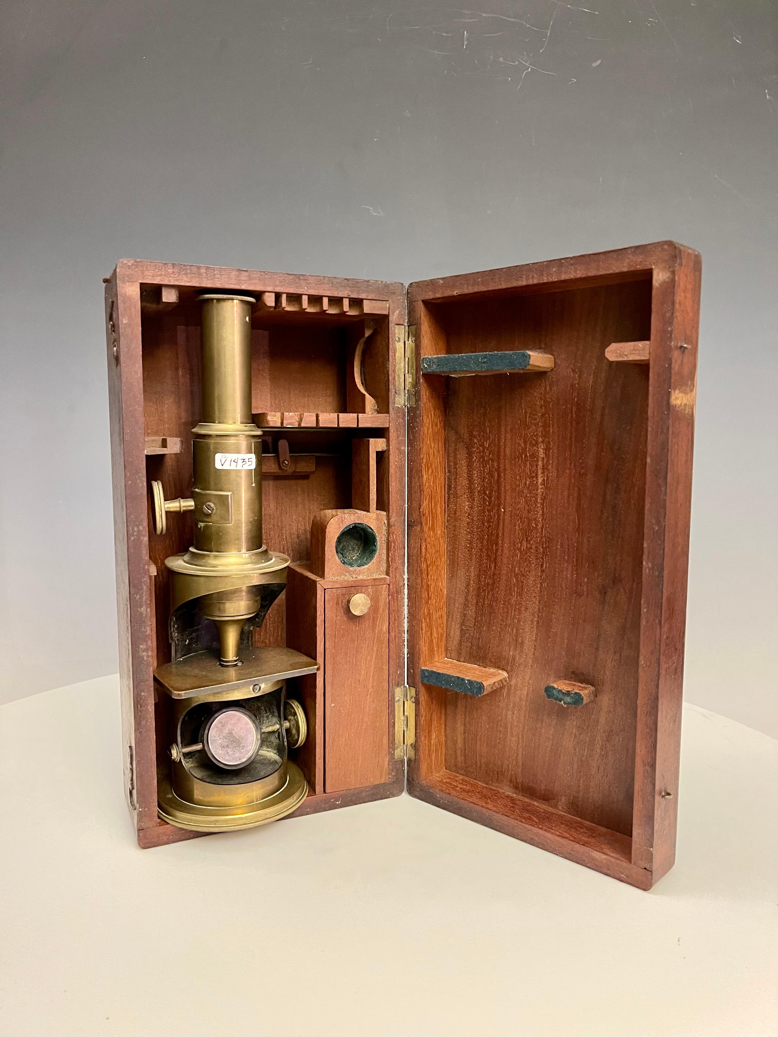 A 19th Century lacquered-brass compund monocular microscope, with draw-tube focusing. Original mahogany case. France, circa 1800.