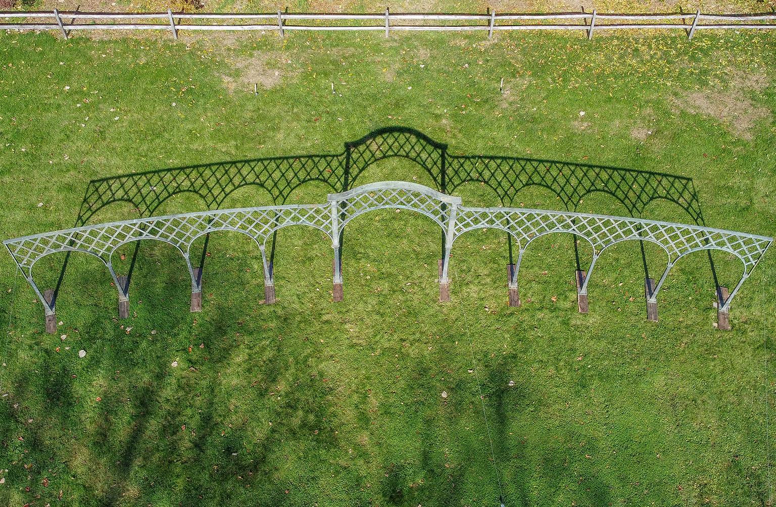 A large bronze arched trellis, in two curved sections, formerly installed at the rose garden at Kykuit, the John D. Rockefeller estate, having been designed by architect Mott Schmitt in 1952, and installed sometime between 1952 and 1957. It was