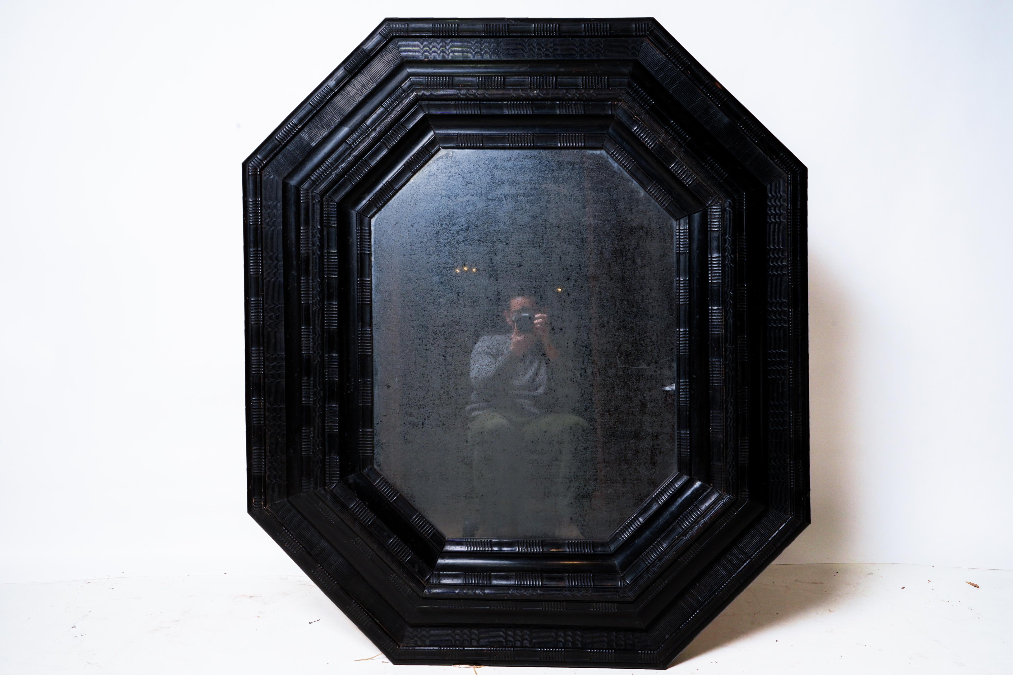 An exceptional Northern Italian baroque ebonized frame, inset with old silvered glass. The thick frame features cove-carved 'ripple' molding, which was then ebonized. Frames of this style are usually referred to as 