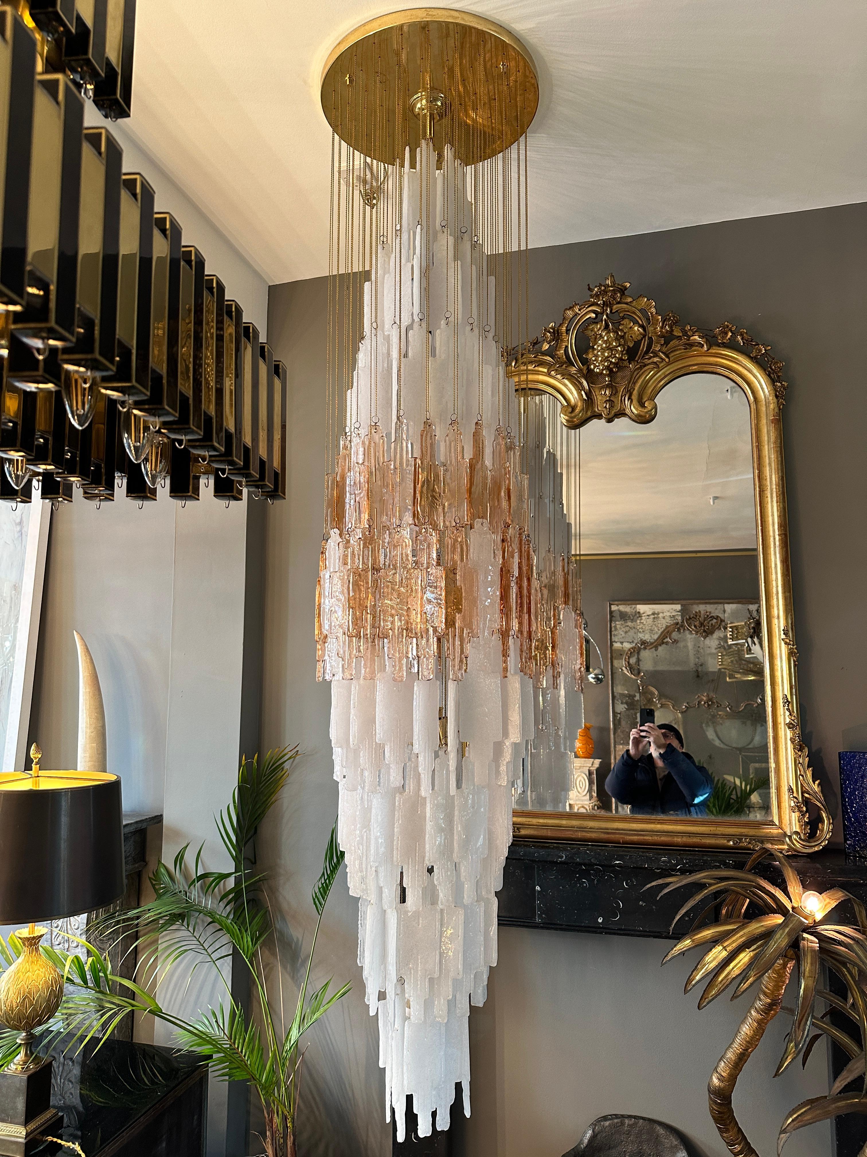 A very large  waterfall Pendant by Albano Poli for Poliarte. A unique model with frosted and Rose coloured Murano glass pieces suspended on gold chains from a circular gilt brass ceiling plate. There are 12 bulbs hung from the centre. There are