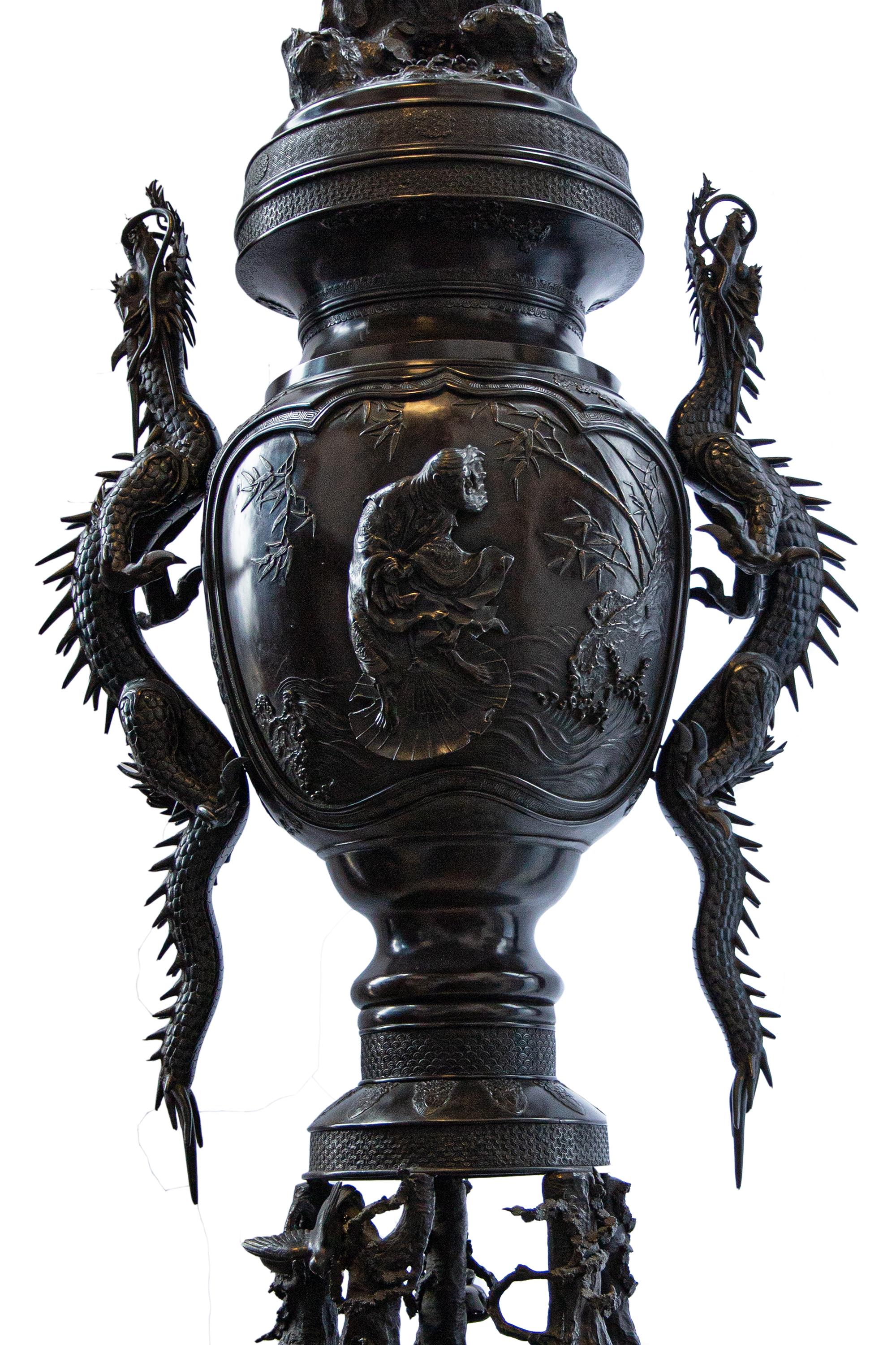 A fine Japanese Meiji period incense burner surmounted by an eagle on rockwork above a vase-shaped, dragon on each side, raised on a circular base with six feet.
 