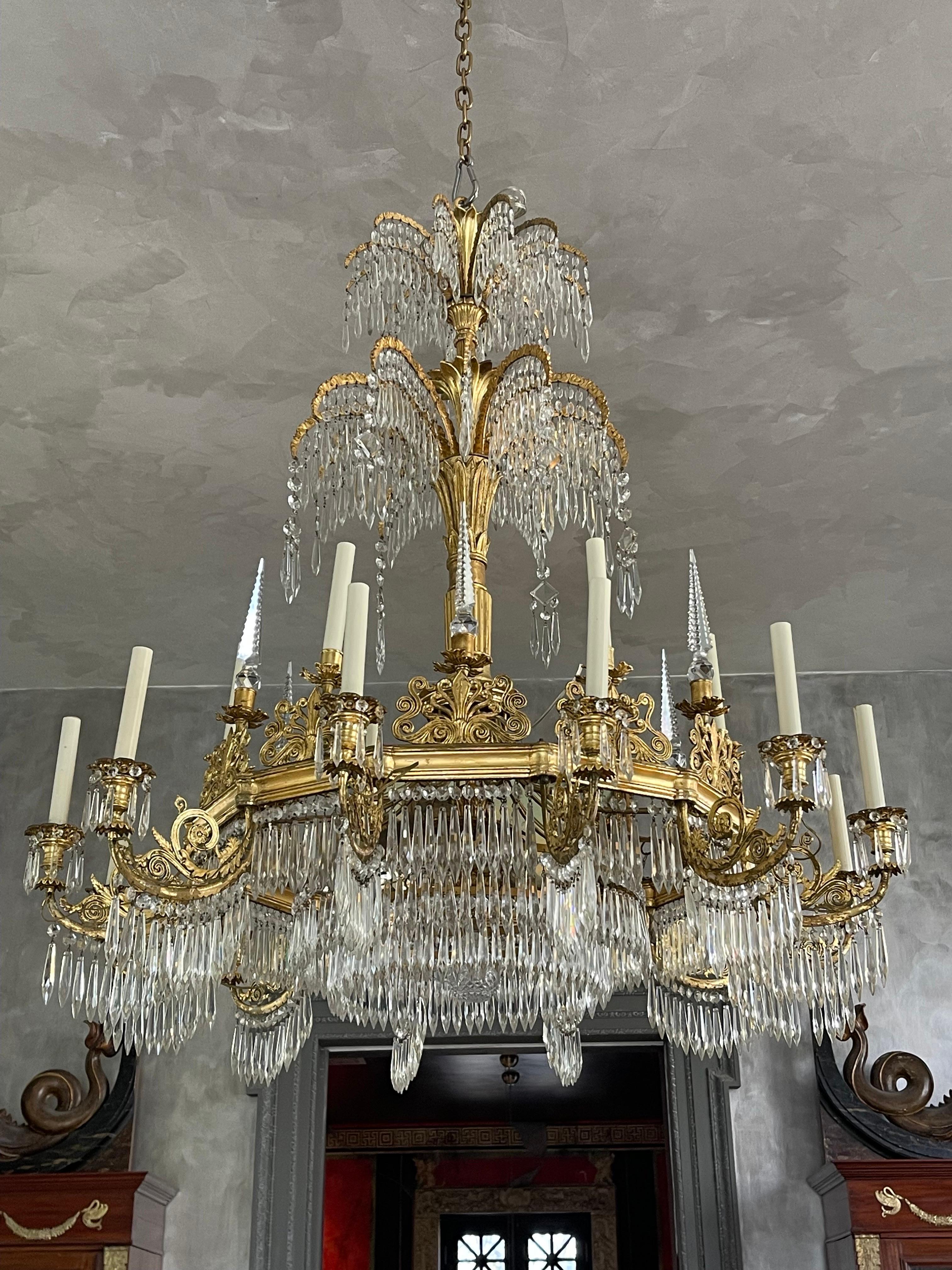 Magnificent Empire period gilt metal and crystal 18 arm chandelier designed by Germany’s premier architect at the time Karl Friedrich Schinkel, who was responsible for erecting most of the palaces in Berlin and most notably the “Altes Museum”.