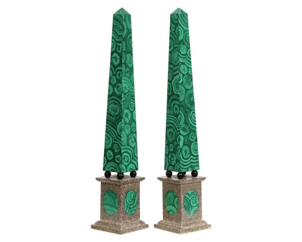 A Monumental Pair of Faux Malachite Painted Obelisks, 20th century. 

Very vibrant, large, and decorative.

40″ high x 7.5″ wide x 7.5″

Very good overall condition. Minor wear, some small nicks to the edges.

Due to the item's age do not expect