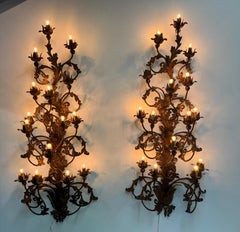 A monumental pair of Venetian gilt iron wall sconces