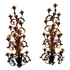 A monumental pair of Venetian gilt iron wall sconces