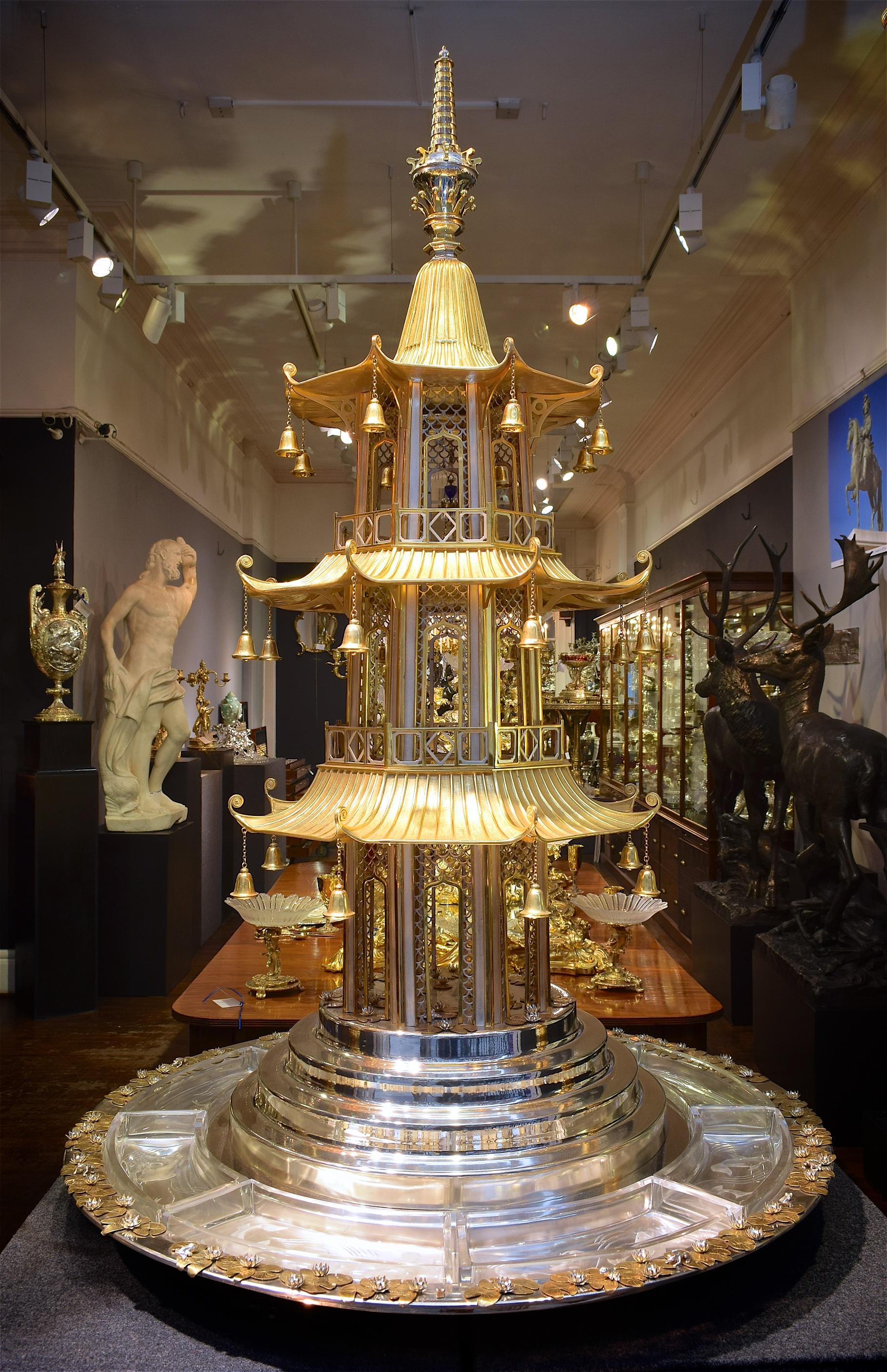 An almost-certainly unique object, the pagoda section hallmarked for Asprey, London 1989

Formed as a pagoda on a stepped plinth, above a round base with eight removable glass dishes, each engraved with swimming fish. The base & plinth further