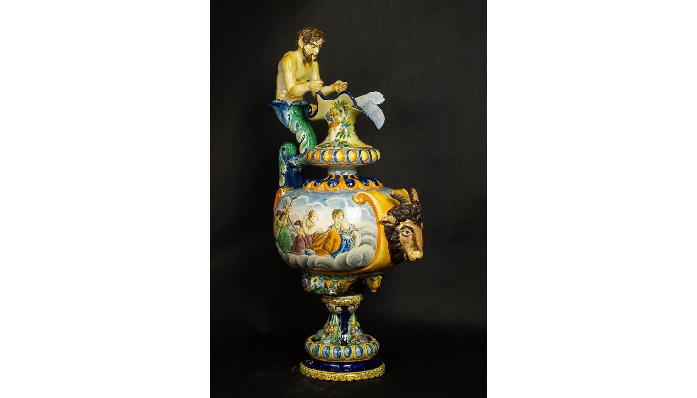Monumental vase made of majolica hand painted in the style of the Italian Renaissance. The rich compositions refer to mythological scenes. Abundant ornamentation and characteristic colours refer to the famous dishes of Urbino from the 16th century.