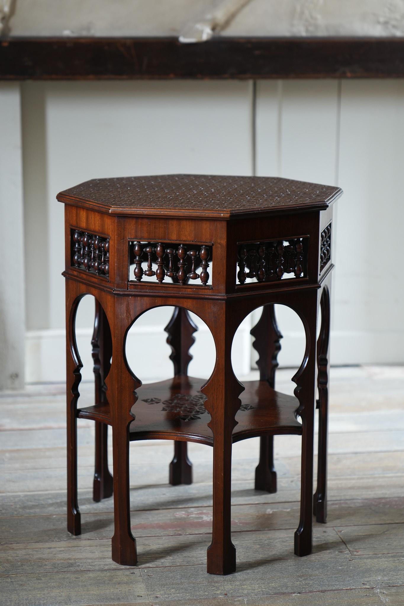 The chip carved octagonal top supported on Moorish lancets with under tier.

Excellent condition throughout.