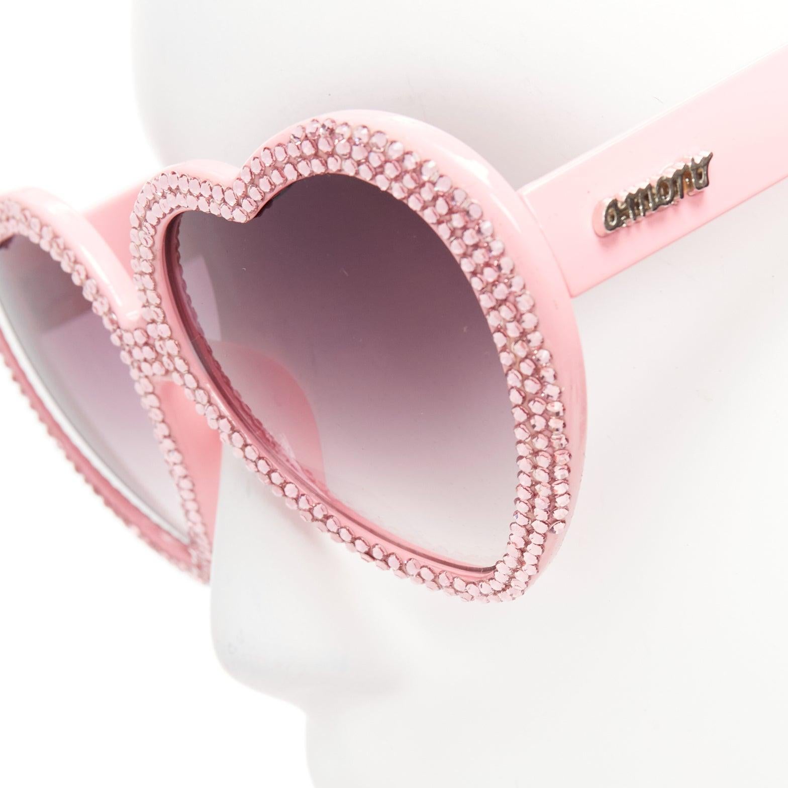A-MORIR pink crystal encrusted heart shape silver logo sunglaseses
Reference: LNKO/A02382
Brand: A-morir
Material: Plastic
Color: Pink
Pattern: Crystals
Lining: Pink 
Extra Details: Silver logos at sides.

CONDITION:
Condition: Excellent, this item