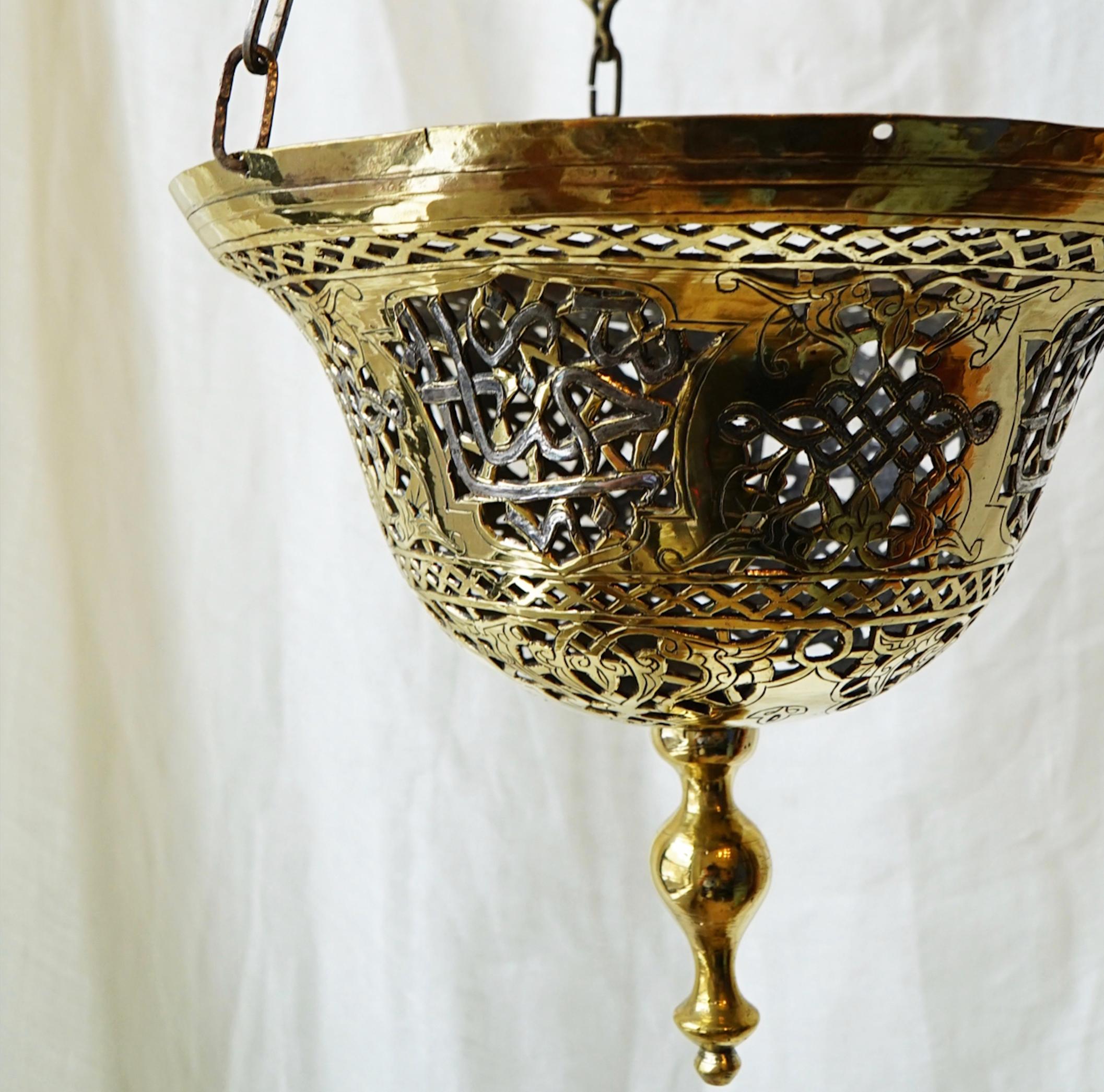 This pierced metalwork pendant from the 1940s which throws filtered light on the walls and ceilings, features Arabic calligraphy. These fixtures used to be quite common in the Imperial Moroccan cities of that time but have become rare to find. This