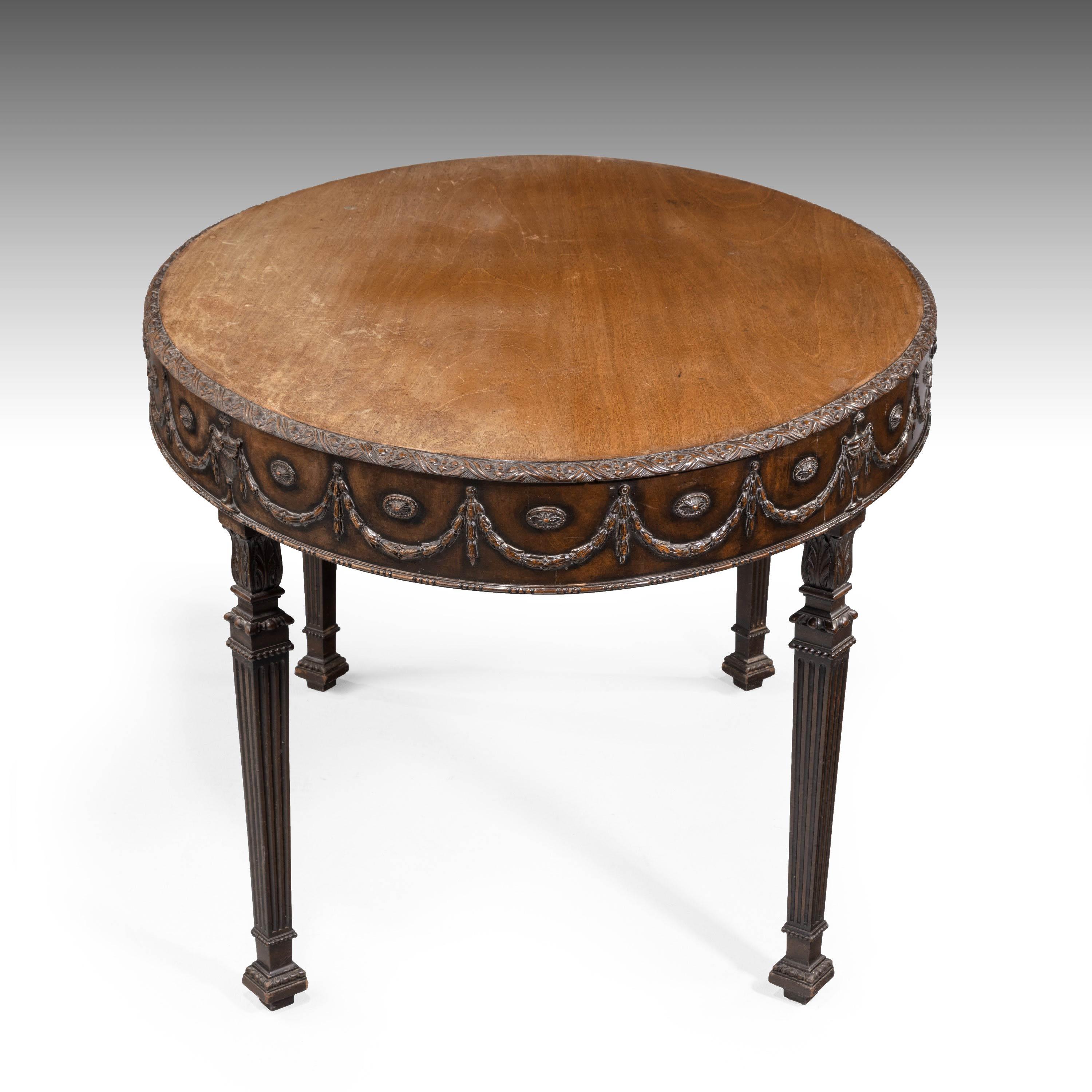 A most attractive oval centre standing table. Influenced by Robert Adam. With swags foliage and carved edge. Excellent overall quality. On square slender supports. Elaborate carving.
 