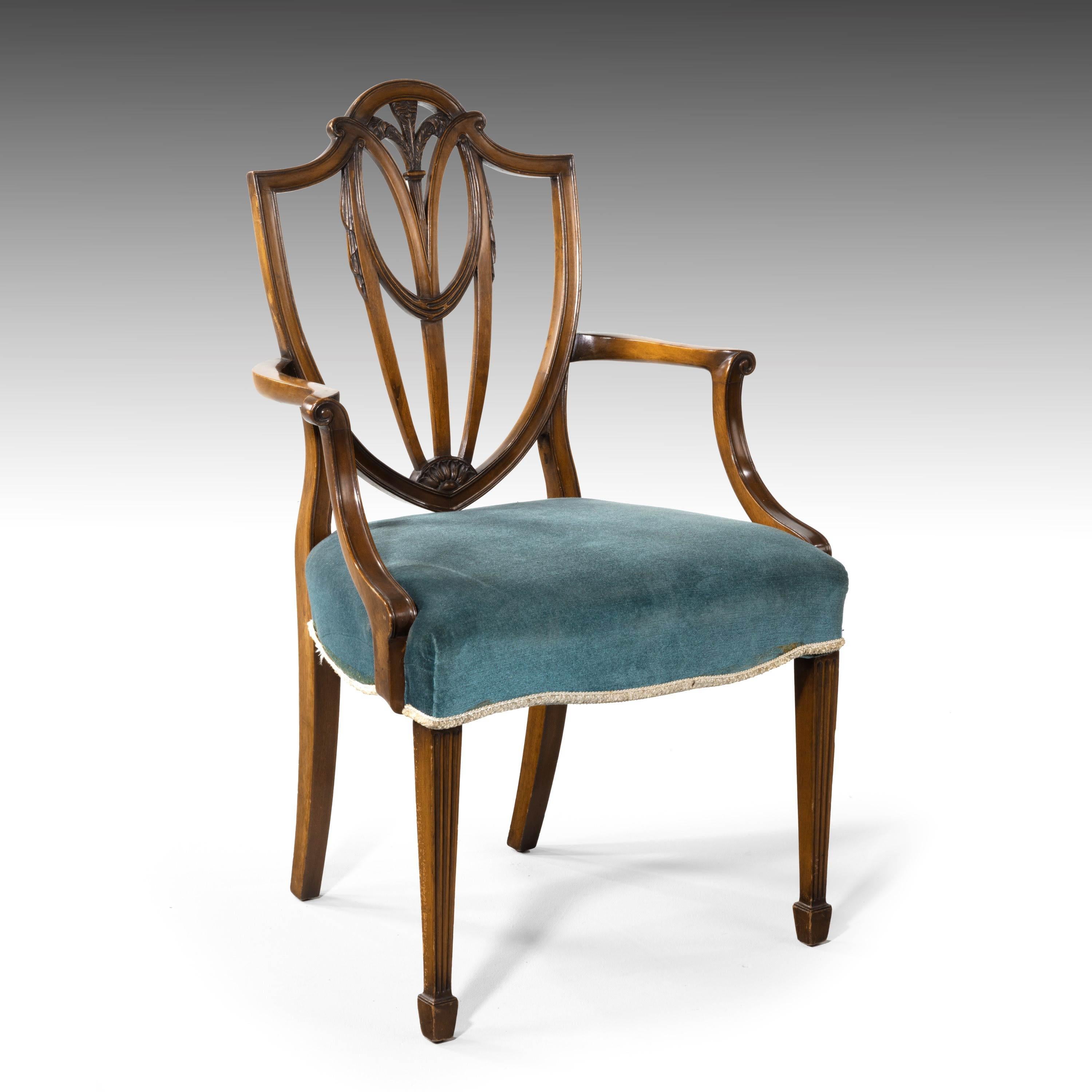 A most attractive set of 8 (6+2) Hepplewhite mahogany framed chairs of classical form. The high arched back with the finely carved plumes of the Prince of Wales feathers and drapes. Square tapering legs ending in block feet. With overstuffed horse