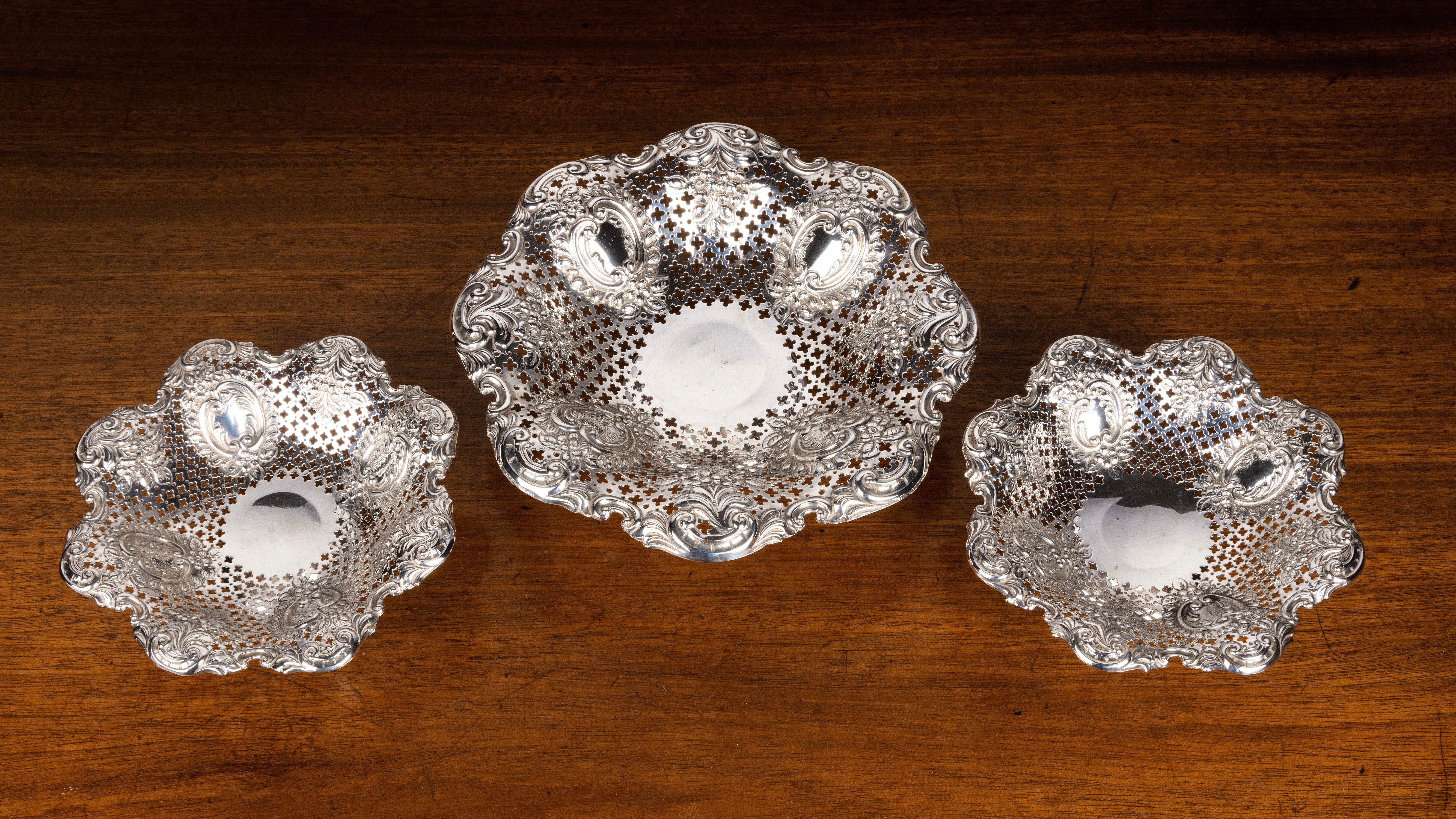 A most attractive suite of three silver pierced and fluted dishes. 1896 and 1897. Elaborately pierced repousse borders with oval reserved panels. 
 
Measures: 2 dishes x height 2 inches x diameter 6 inches 132.6 grams = 4.3 troy ounces
1 dish x