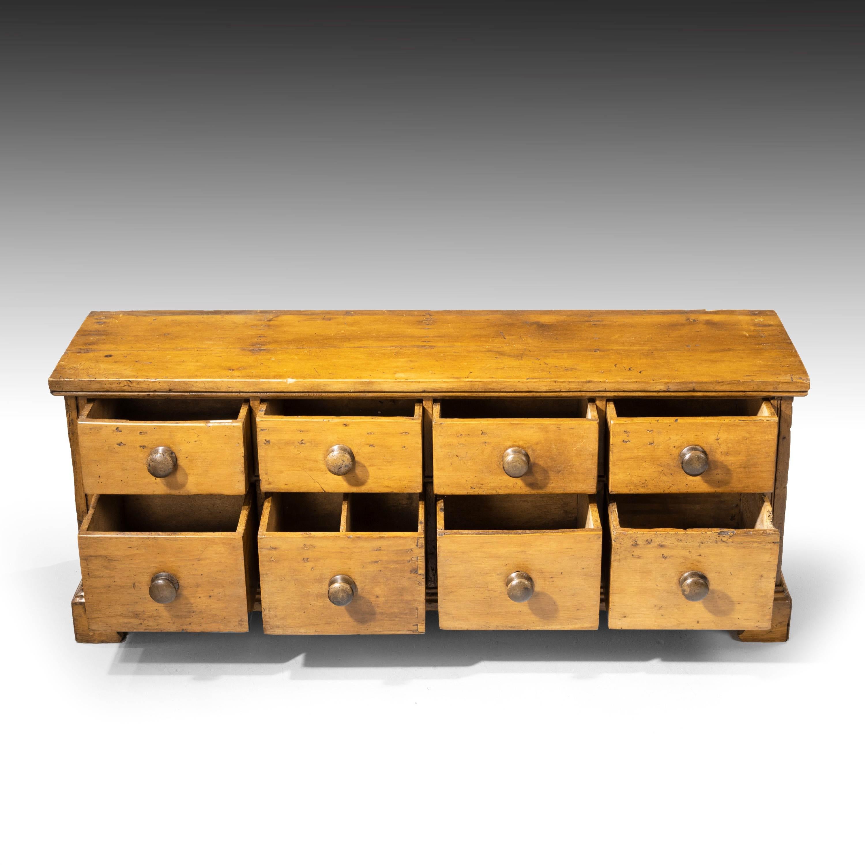 A most unusual pine chest of drawers of two banks. On original bracket feet.
  