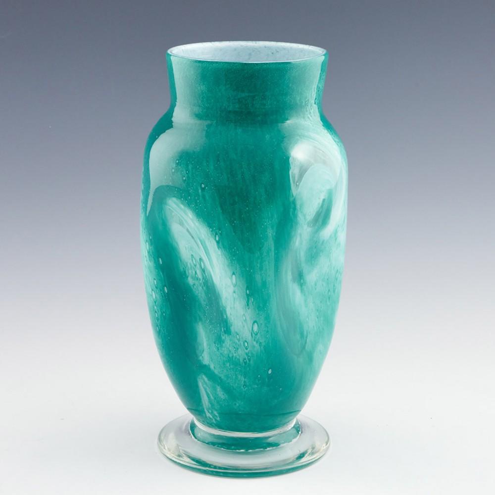 Gray-Stan vase made c1930 in London, England. Mottled green over mottled white over clear; a squarelike form with dimpled faces transitioning to a round neck. Applied clear glass foot. Incised signature Gray-Stan on base.

Weight : 1271