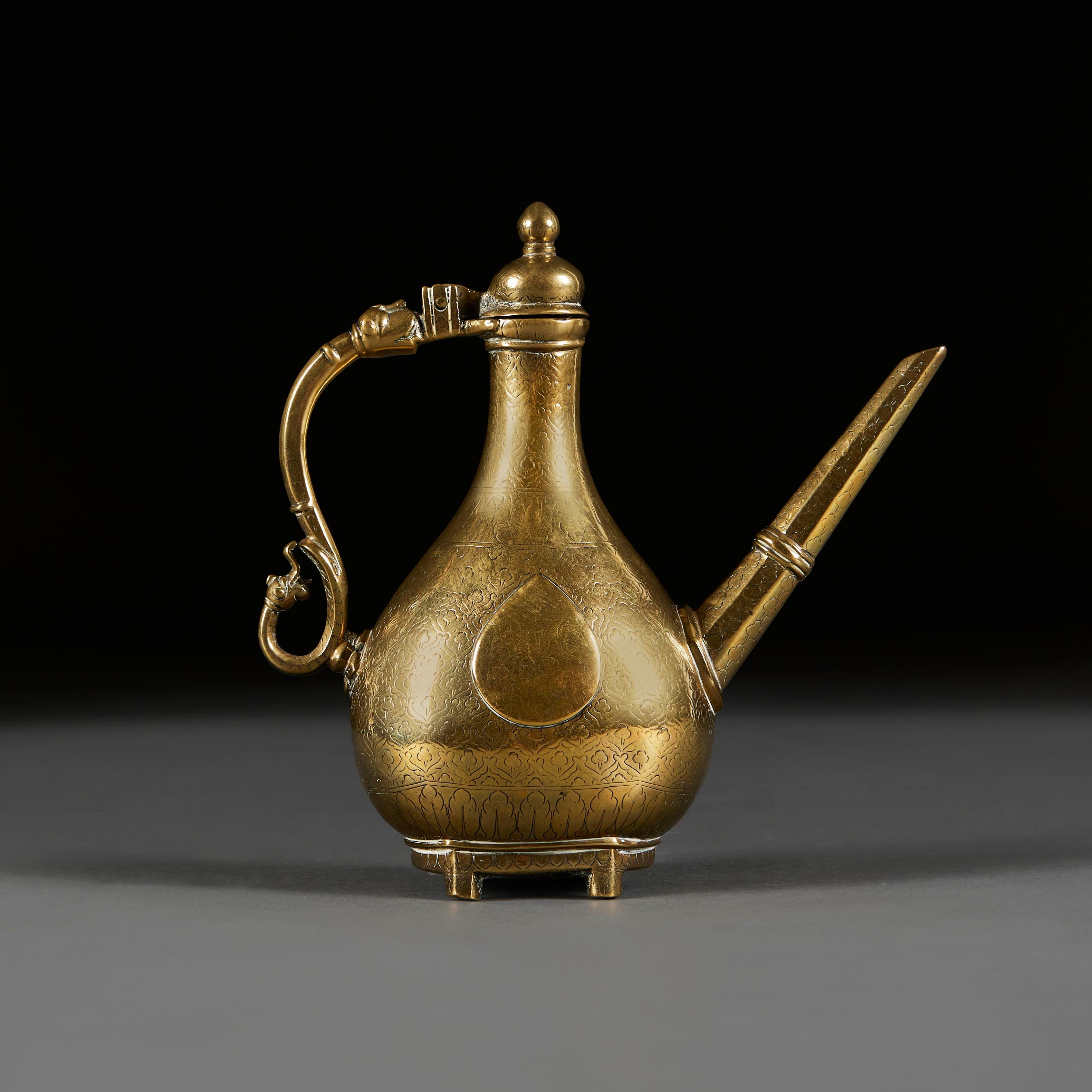Eine Mitte des achtzehnten Jahrhunderts Mughal Messing Kaffeekanne birnenförmig, mit tropfenförmigen Platten auf jeder Seite über eine ziselierte Dreiblatt-Motiv, mit linearen Auslauf auf der einen Seite und Scrolling Griff auf der anderen mit einem