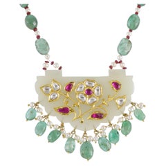 A Mughal Gem-set Indian Jade pendant inlaid with gold diamond, ruby and emeralds