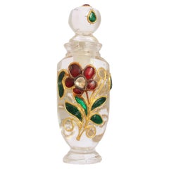 A Mughal Natural Rock Crystal Perfume Flask inlaid with gold and rubies