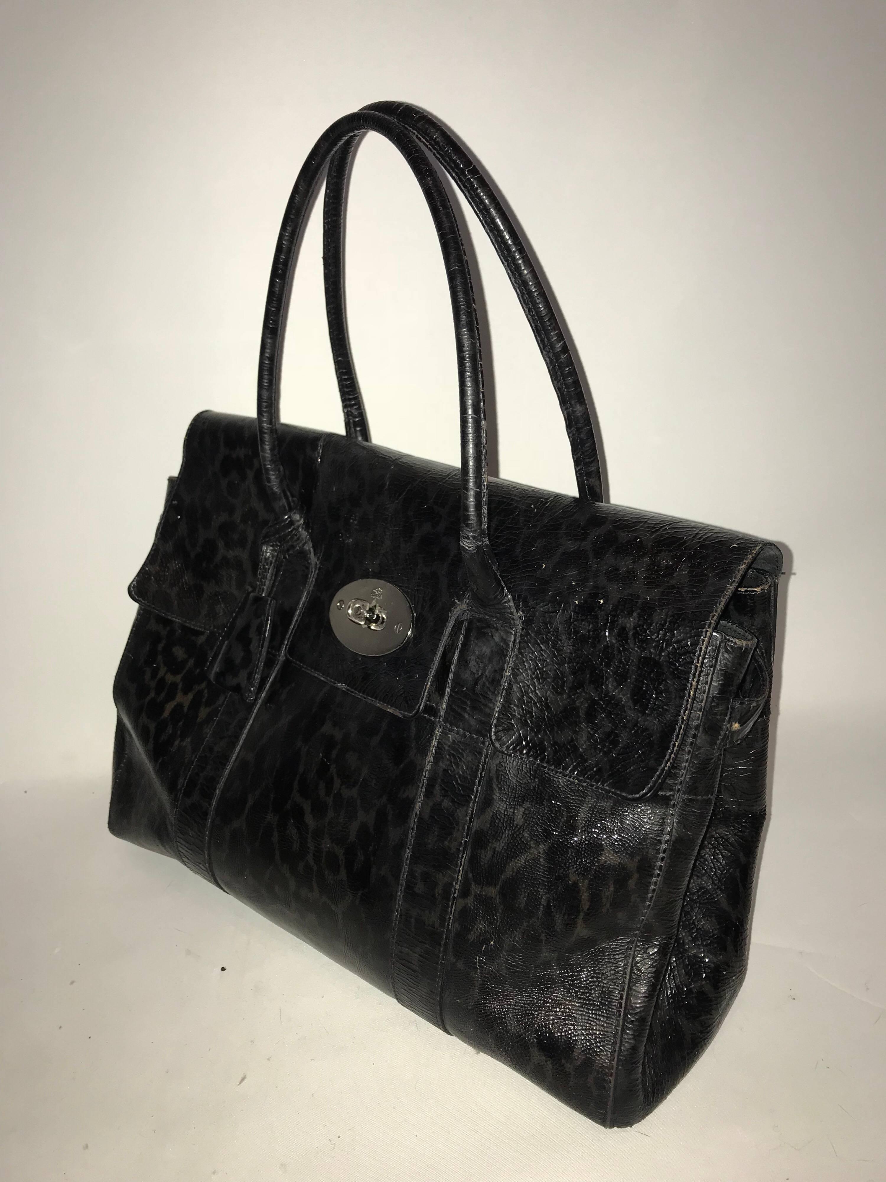 This authentic Mulberry Bayswater leopard print Satchel bag in a blue/black colour 

It showcases the brand's simple iconic design made for everyday use. Crafted from patent leather, this industrial-style tote features tall dual-rolled leather