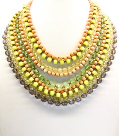 A  multi row, multi coloured glass bead necklace, and earrings, De Mario, 1950s